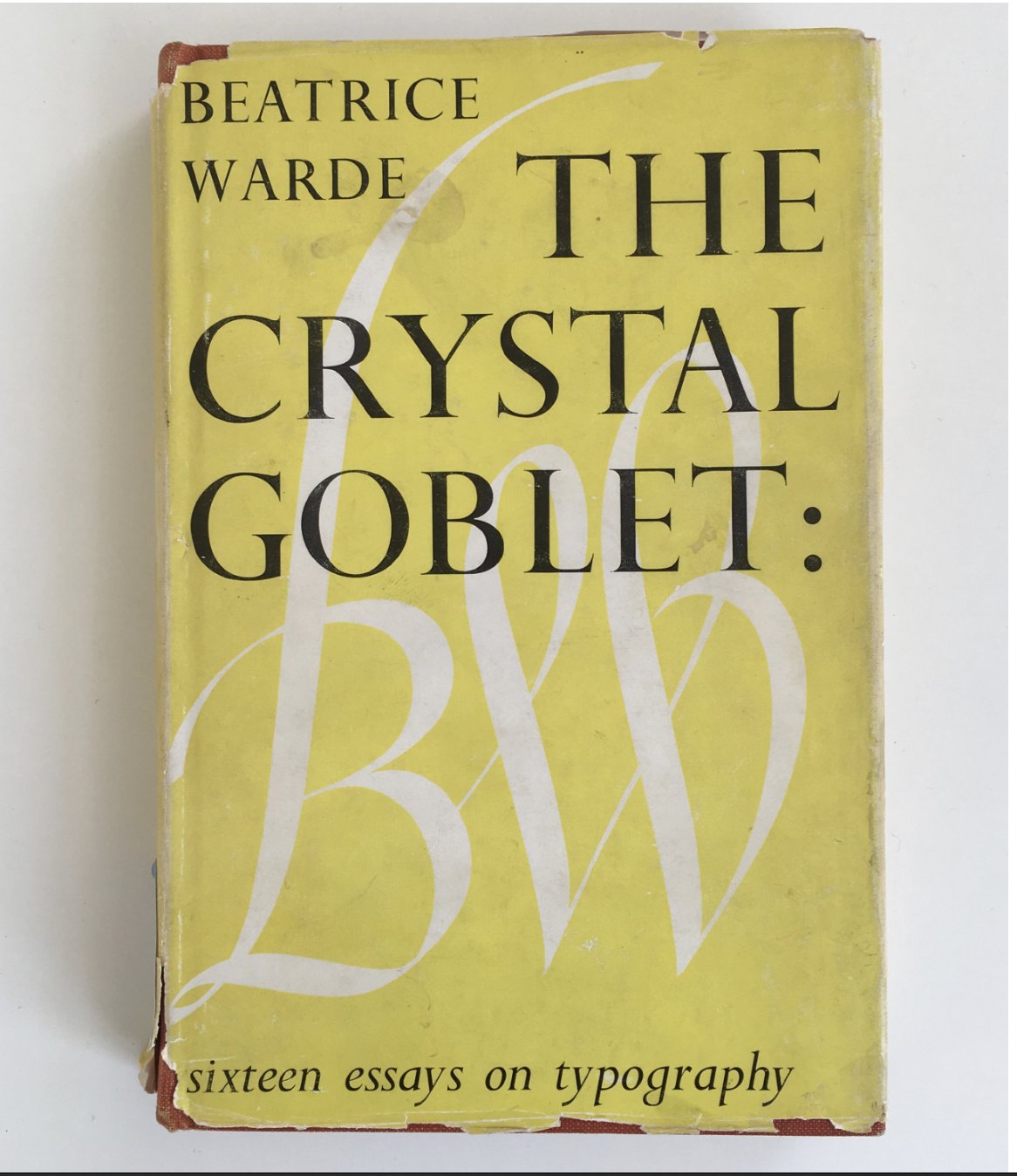 Beatrice Warde&rsquo;s book, The Crystal Goblet, sixteen essays on typography, in a worn yellow jacket